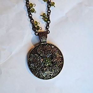 Gold tone and green crystal necklace